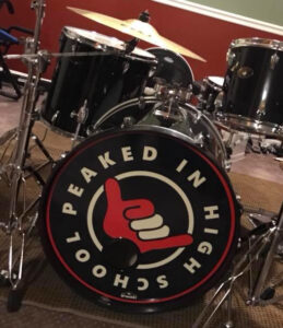 Peaked In High School logo by Tom Bruton